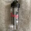 Water bottle, clear, black top, with straw, ice